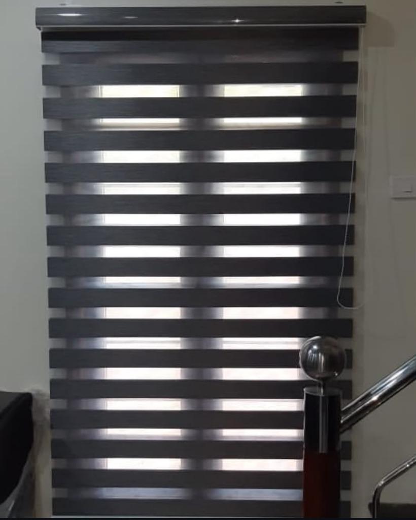 Grey zebra blinds installed on staircase window
