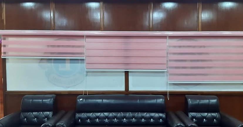 Pink zebra blinds close up view in office room